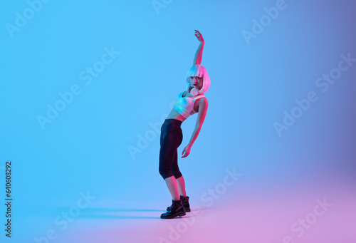 Fit woman dancing in neon light