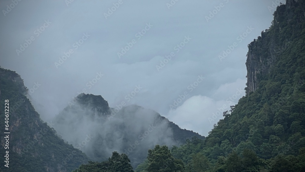 Scenic view of  misty mountain in winter season at  Doi Pha Hee, Chiang Rai, Thailand.