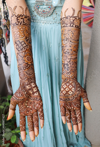 he Bride displays decoration of her hands with Henna Mehndi designed in Arabic style during a Wedding ceremony in India. photo