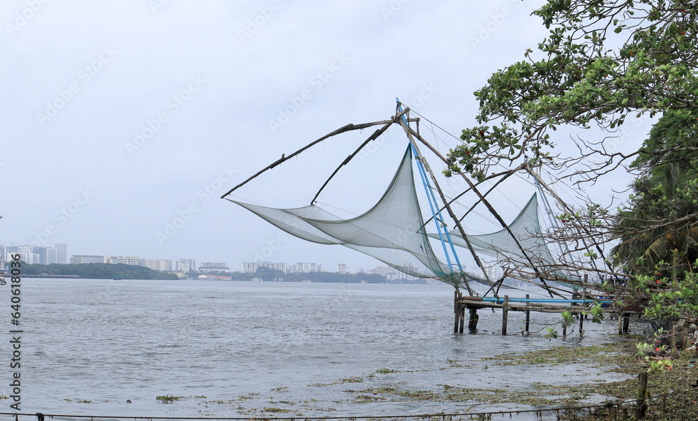 An Eye catching view of series of Chinese fishing nets lined up in the sea coast of Kochi in Kerala Backwaters, India.  .