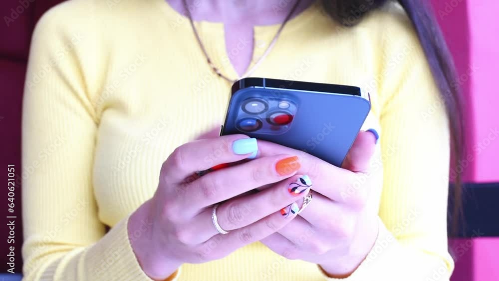 Girl uses smartphone pressing fingers. Close-up girl with smartphine sitting in social medias , typing messages. Freelancer works with iphone in cafe Girl uses smartphone pressing fingers. Close-up girl with smartphine sitting in social medias , typing messages. Freelancer works with iphone in cafe