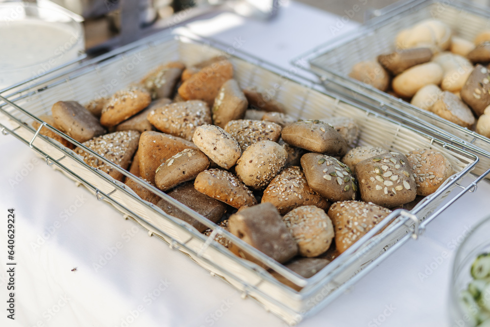 Multigrain bread rolls in a tray at a buffet