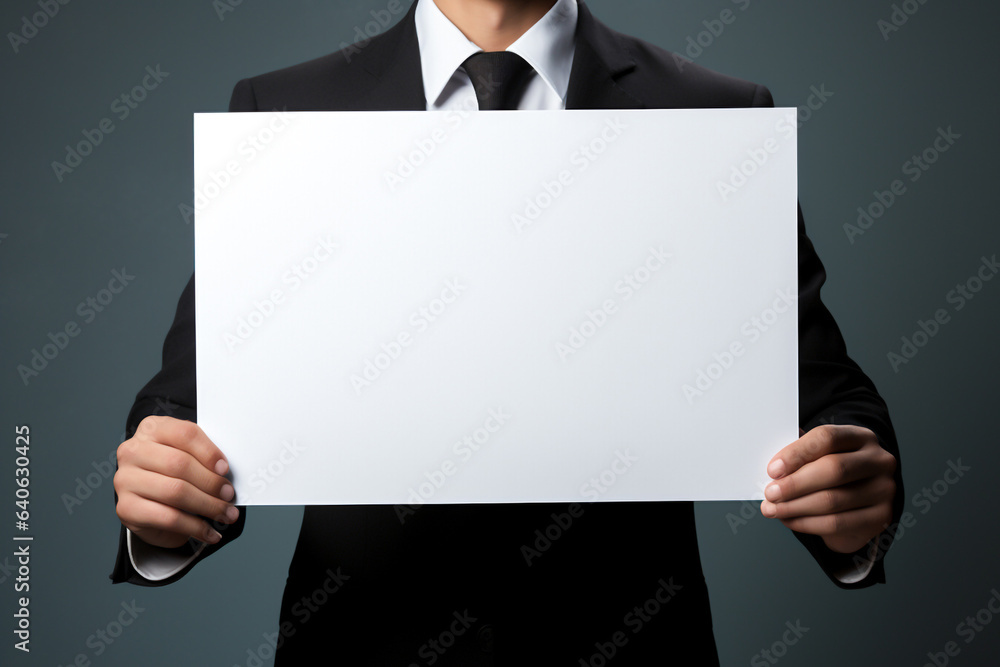 unrecognizable businessman wearing suit holding a empty sign for copy space. Blank poster for message and information unrecognizable businessman wearing suit holding a empty sign for copy space. Blank poster for message and information