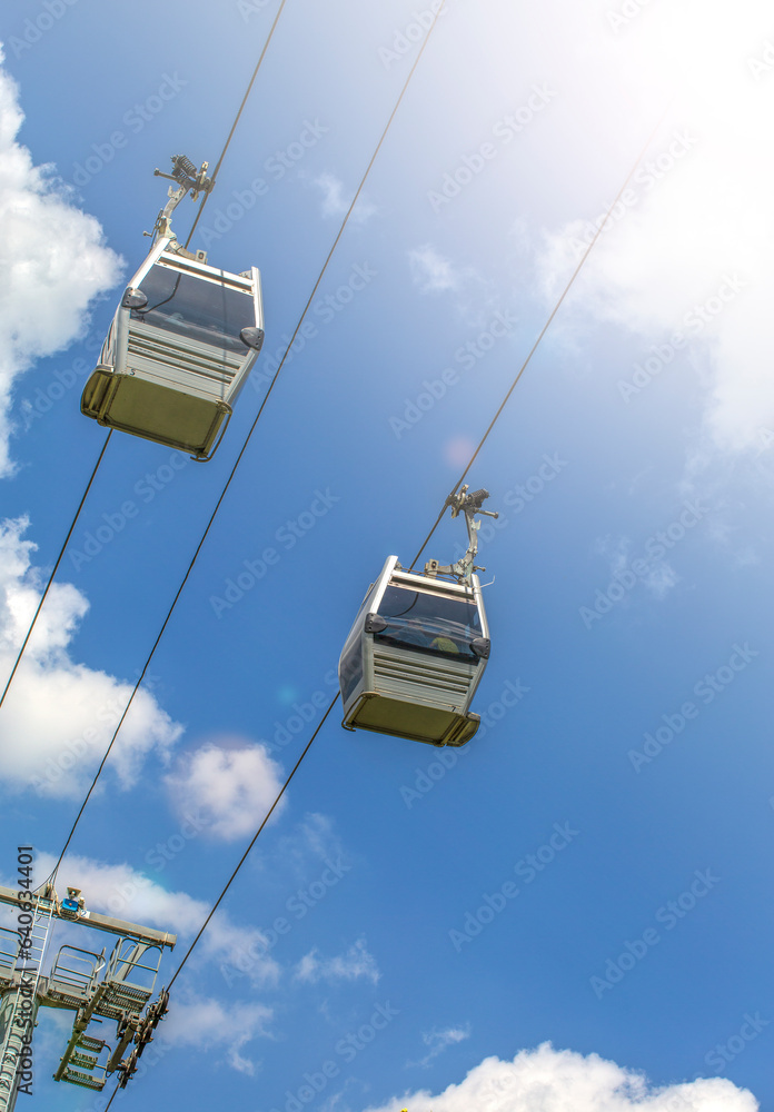 Cable car cabins against blue sky and clouds. Georgia Cable car cabins against blue sky and clouds. Georgia