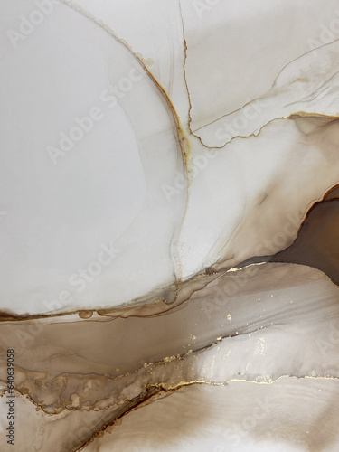 Abstract beige marble art with gold — brown transparent background. Beautiful smudges and stains made with alcohol ink and golden paint. Beige fluid art texture resembles watercolor or aquarelle.