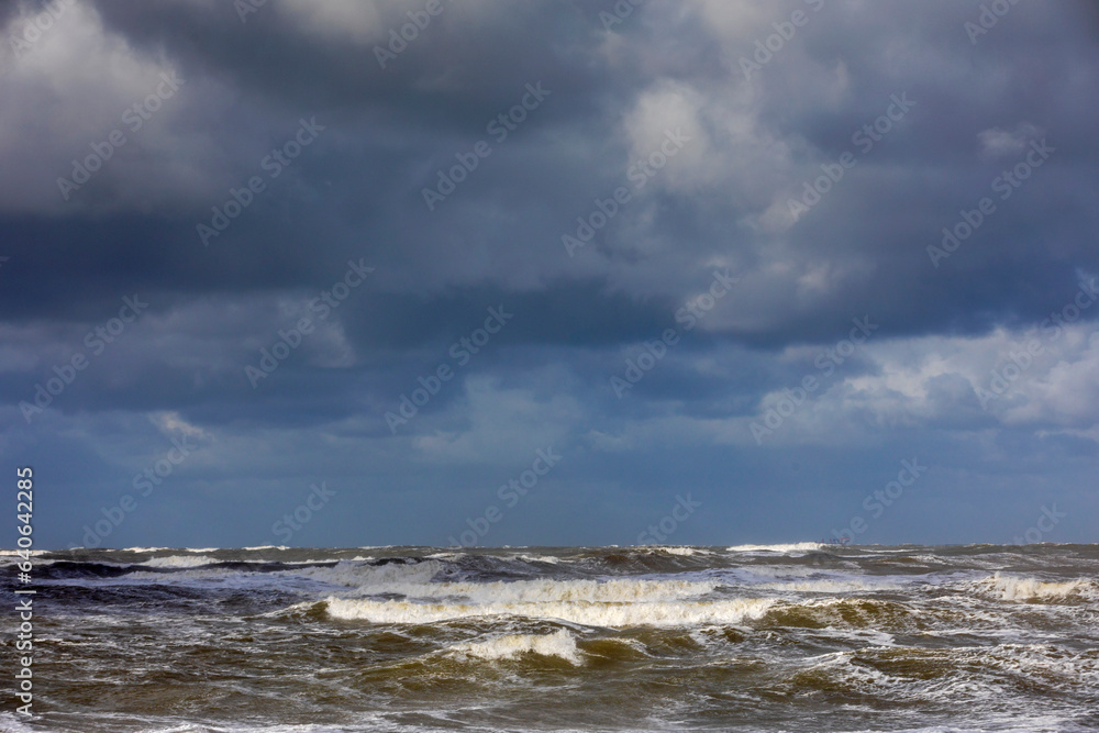 stormy weather with dark clouds and rough waves on the North Sea along the Dutch coast stormy weather with dark clouds and rough waves on the North Sea along the Dutch coast
