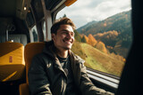 Happy, smiling young man traveling in train.