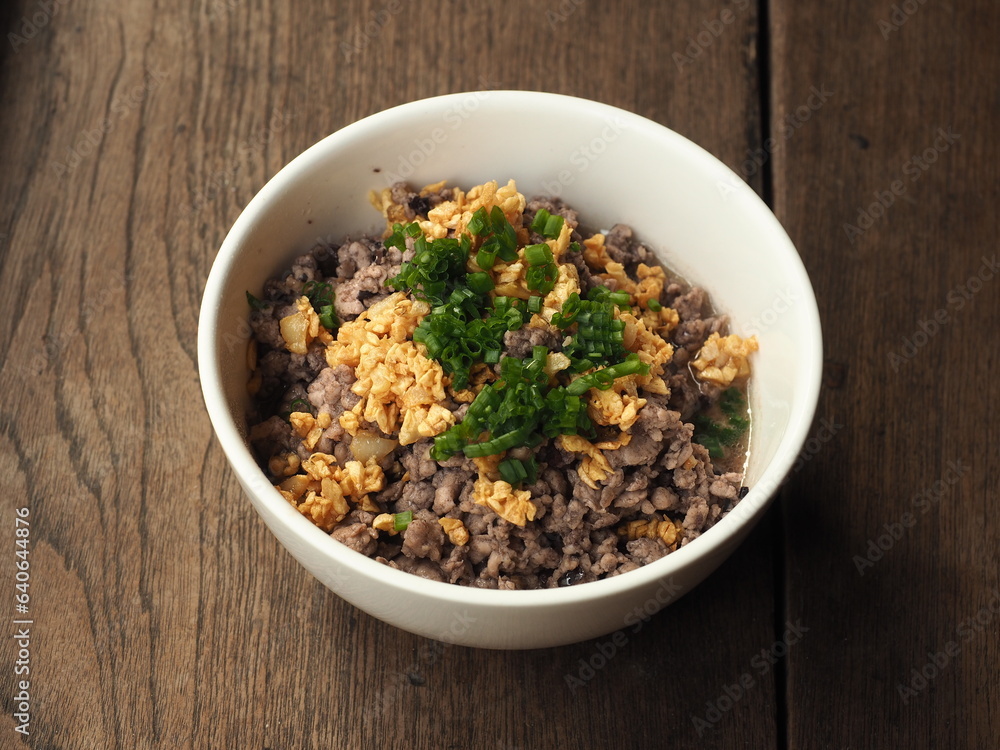 bowl of stir fried minced pork with Chinese black olive with chopped spring onion and crispy golden garlic topping bowl of stir fried minced pork with Chinese black olive with chopped spring onion and crispy golden garlic topping