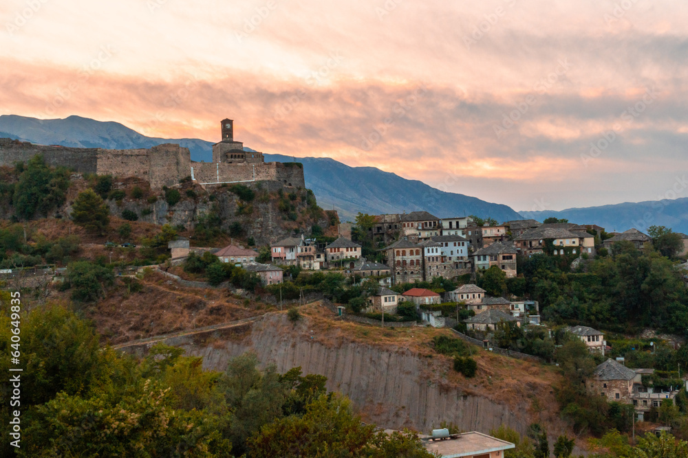Sunset over the clock tower and fortress of Gjirokaster, Albania