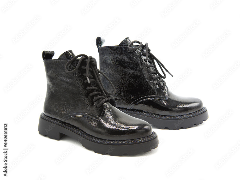 Pair of fashionable patent leather boots isolated on white background. Pair of fashionable patent leather boots isolated on white background.