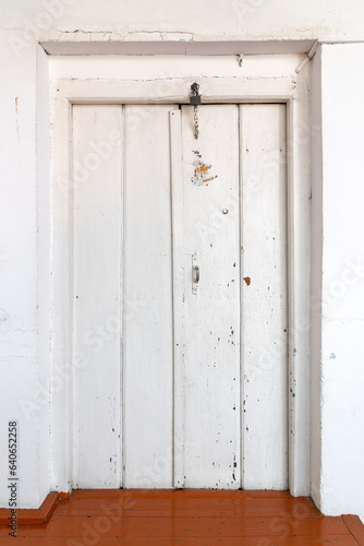 Old wooden painted door of a rural house