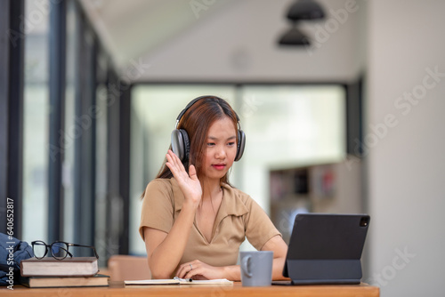 Asian female college students learn from remote online classes. Learn to make video calls online.