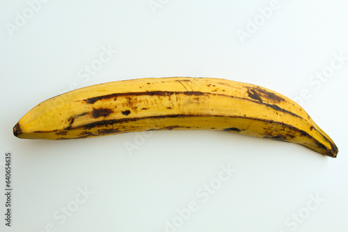 One banana. Long ripe yellow banana. Isolated on white background