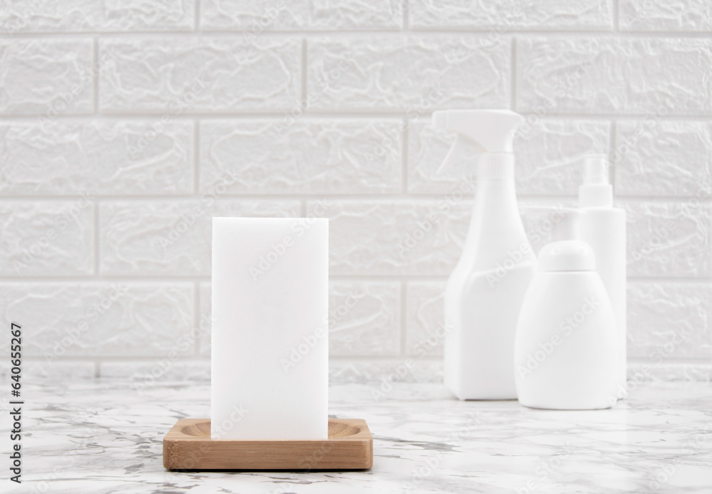 Melamine white sponge on the marble table with cleaning product. Cleaning concept and household. Melamine white sponge on the marble table with cleaning product. Cleaning concept and household.