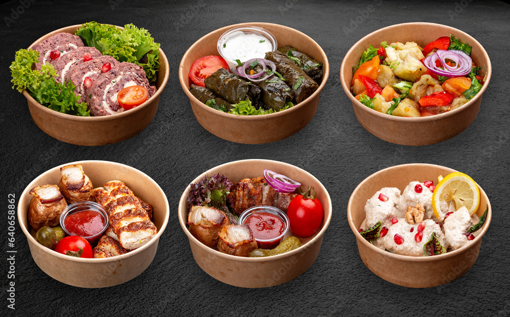 A set of Caucasian cuisine dishes in a takeaway package. Isolated on a dark background A set of Caucasian cuisine dishes in a takeaway package. Isolated on a dark background