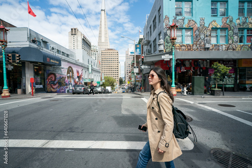 Photography side view of asian Japanese businesswoman walking across street intersection wit