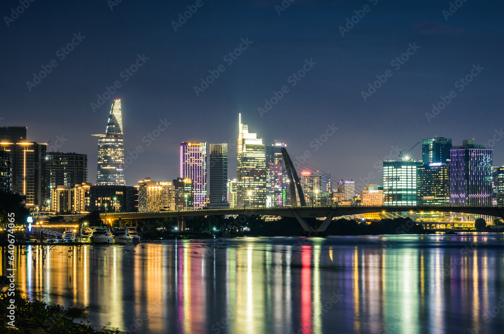 Ho Chi Minh City skyline and the Saigon River at sunset.  It is a popular tourist destination of Vietnam.