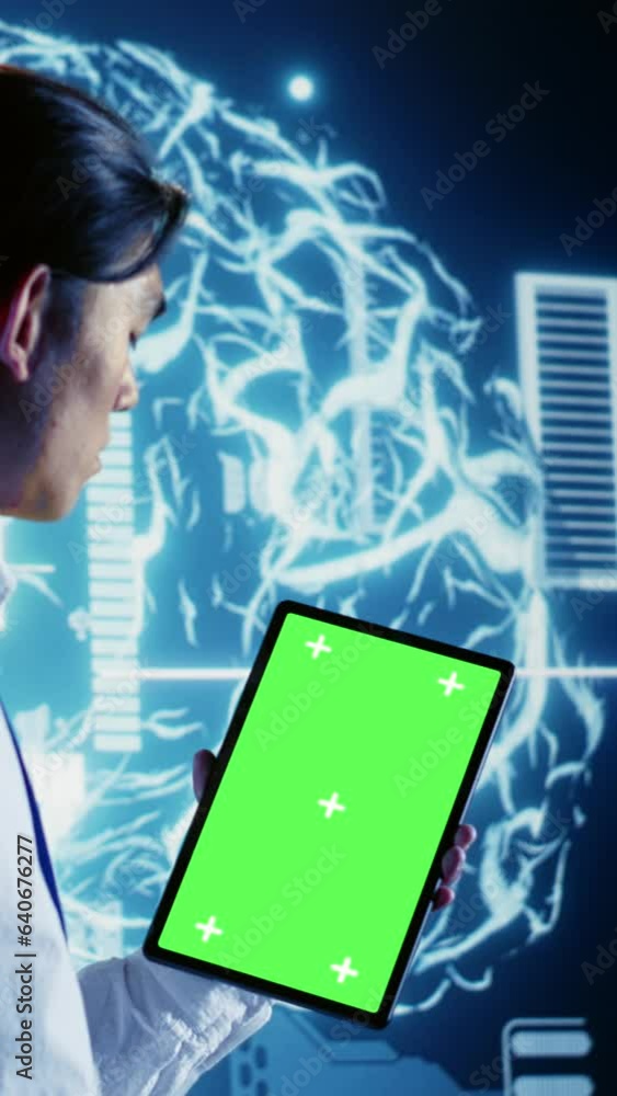 Vertical video Tech savvy IT practitioner using green screen tablet to ...