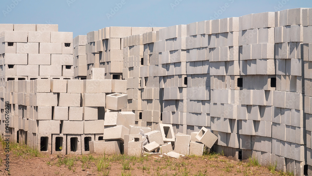 Concrete blocks, stacked high in a field, for construction of single-family houses in a suburban planned community in southwest Florida. For motifs of abundance, supply and demand, land development. Concrete blocks, stacked high in a field, for construction of single-family houses in a suburban planned community in southwest Florida. For motifs of abundance, supply and demand, land development.
