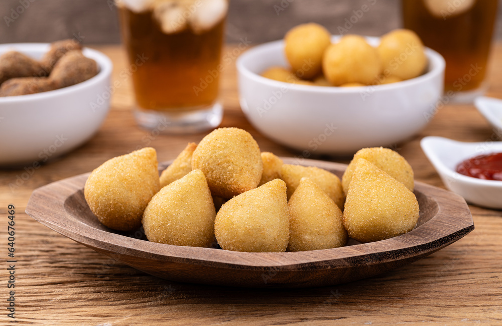 Typical brazilian snack coxinha on a plate with soda glass, ketchup and mustard Typical brazilian snack coxinha on a plate with soda glass, ketchup and mustard