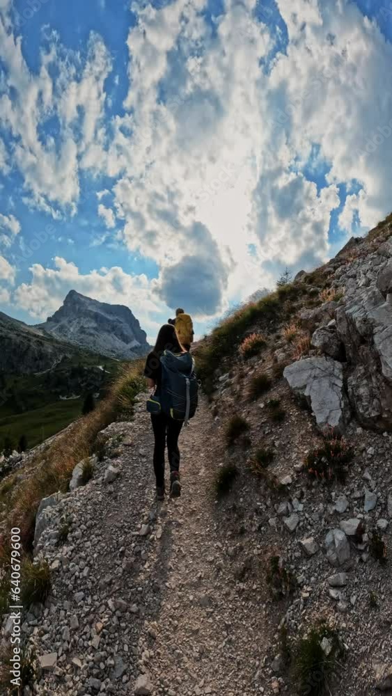 Vertical screen shot people with backpacks hiking trail path and climbing Dolomites mountain. Group of friends on top of the mountain. Travel exploring Alps, Dolomites Vertical screen shot people with backpacks hiking trail path and climbing Dolomites mountain. Group of friends on top of the mountain. Travel exploring Alps, Dolomites