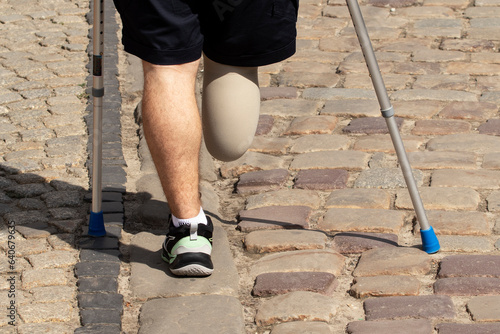 Konstfotografi A man with a disability walks on the sidewalk