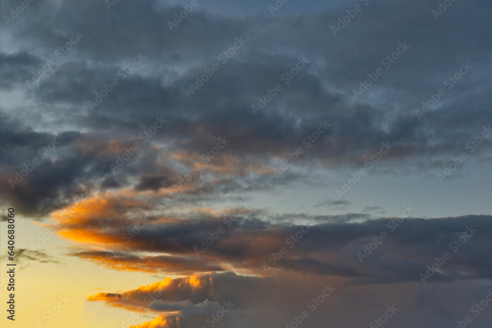 Russia. South of Western Siberia. The clouds illuminated by the setting sun in the evening sky over the endless fields of Altai.