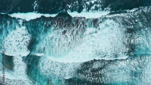 Powerful ocean waves crashing on shoreline. Aerial drone top view from above