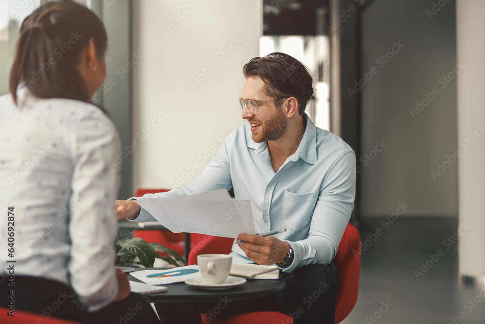 Two business colleagues working with documents together sitting in office.High quality photo Two business colleagues working with documents together sitting in office.High quality photo