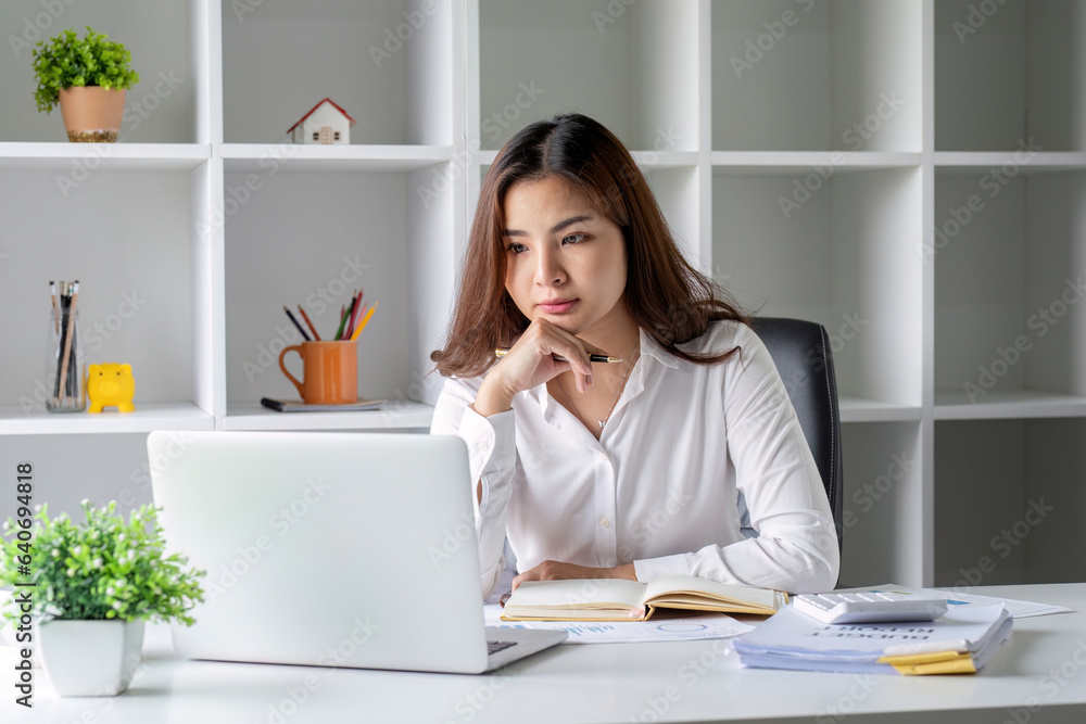 Businesswoman is stressed and tired from working all day at the office. Businesswoman is stressed and tired from working all day at the office.