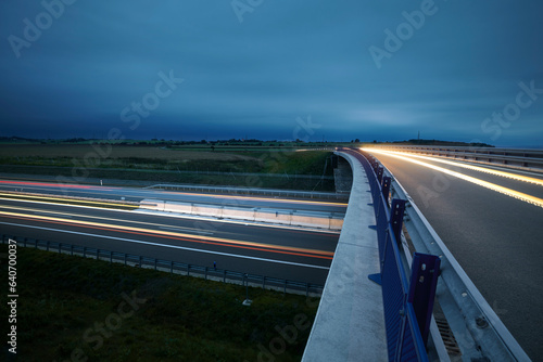 Road overpass over multiple lane highway in countryside at twilight. Themes car transportation, direction and connection.. photo