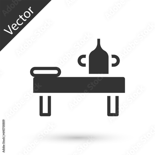 Grey Massage table with oil icon isolated on white background. Vector