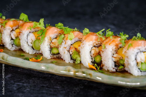 Delicious sushi rolls on traditional marble plate