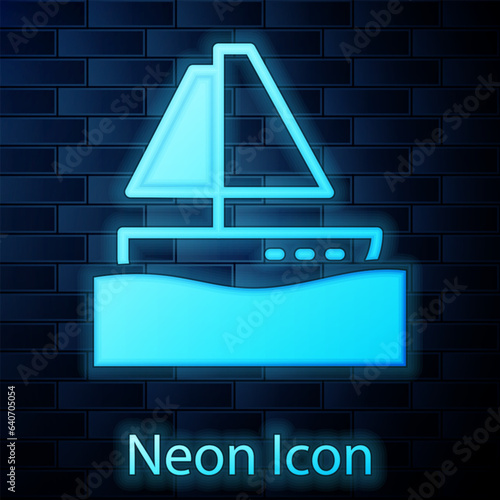 Glowing neon Yacht sailboat or sailing ship icon isolated on brick wall background. Sail boat marine cruise travel. Vector