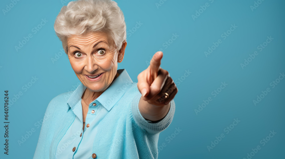 Senior woman wearing casual clothes pointing with hand and finger to the side looking at the camera. Senior woman wearing casual clothes pointing with hand and finger to the side looking at the camera.