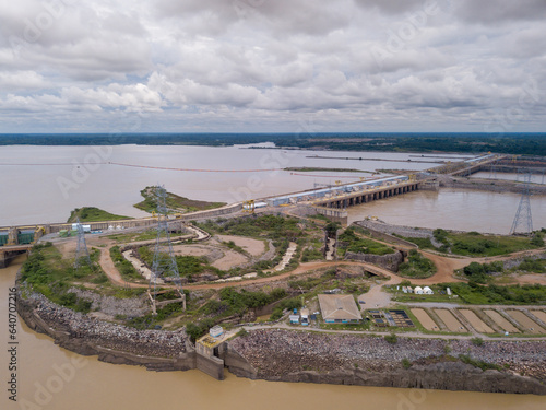 Beautiful drone aerial view of dam on Madeira River, Santo Antônio Hydroelectric Power Plant and Amazon rainforest in Porto Velho city, Rondonia, Brazil. Concept of energy, renewable, sustainable.