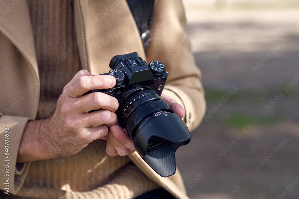 Fototapeta premium Crop male photographer taking photos on camera