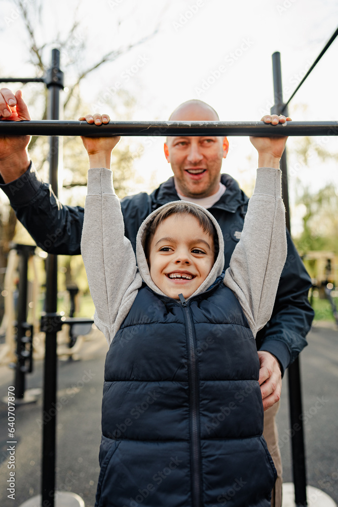 Fototapeta premium Happy father with his son spending time together on a sports ground