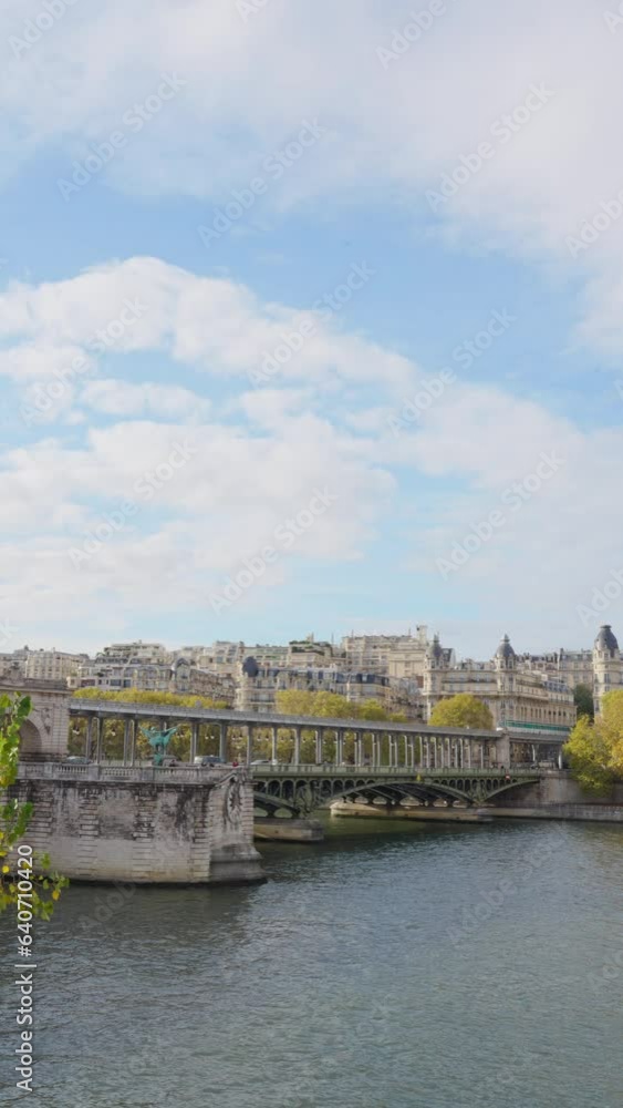 Parisian metro train passing over the Seine river on the Bir-Hakeim viaduct, France. Panorama urban view of Paris city center public transport. Travel destinations landmark of Europe. Vertical screen. Parisian metro train passing over the Seine river on the Bir-Hakeim viaduct, France. Panorama urban view of Paris city center public transport. Travel destinations landmark of Europe. Vertical screen.