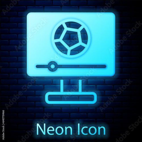 Glowing neon Football soccer match on TV icon isolated on brick wall background. Football online concept. Vector