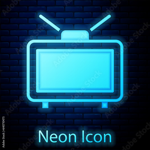 Glowing neon Football soccer match on TV icon isolated on brick wall background. Football online concept. Vector