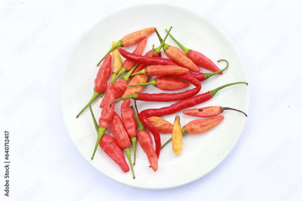 red chili served on a white plate isolated on white background red chili served on a white plate isolated on white background
