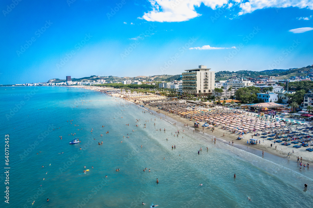  Golem, Durres, Albania - 22 august 2023: Aerial view to sandy beach full of umbrellas and people in summer season 2023
