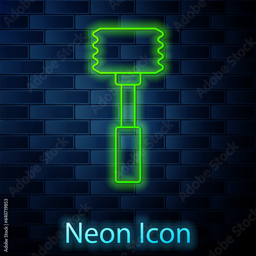 Glowing neon line Kitchen hammer icon isolated on brick wall background. Meat hammer. Vector