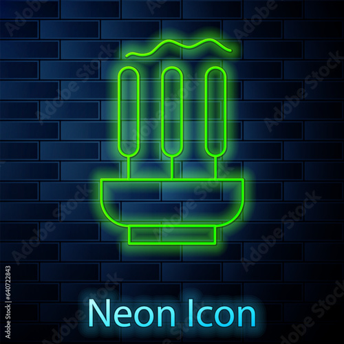 Glowing neon line Burning aromatic incense sticks icon isolated on brick wall background. Vector