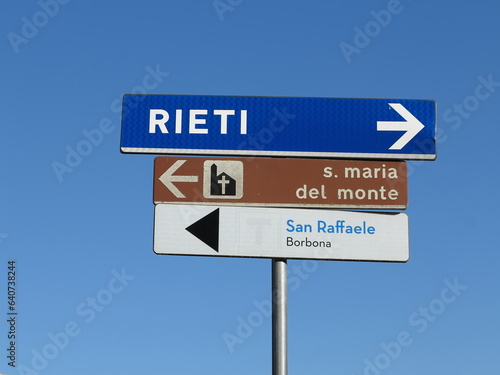 Directions Signs Against a Bright Blue Sky in Borbona, Lazio, Italy photo