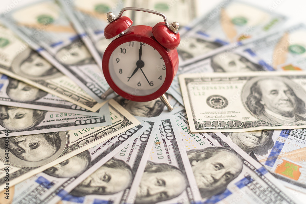 Time is money. Alarm clock and dollar banknotes. Time is money. Alarm clock and dollar banknotes.