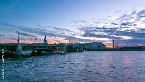 Palace Bridge day to night transition timelapse captures traffic, water mirror reflections. Birzhevoy bridge, Birzhevaya Square, Stock Exchange Building, and Rastralnye columns in Saint-Petersburg photo