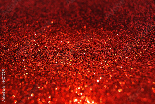 Red de focused sparkle glitter background close up