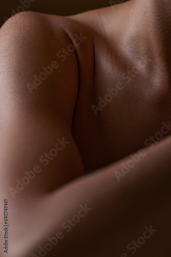 Body, closeup and healthy skin of black woman, shoulder or natural glow from skincare in studio with antiaging cosmetics. Beauty, self care and arm of model with clean, hygiene and aesthetic wellness